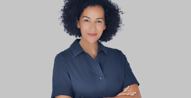 a woman with curly hair wearing a blue shirt