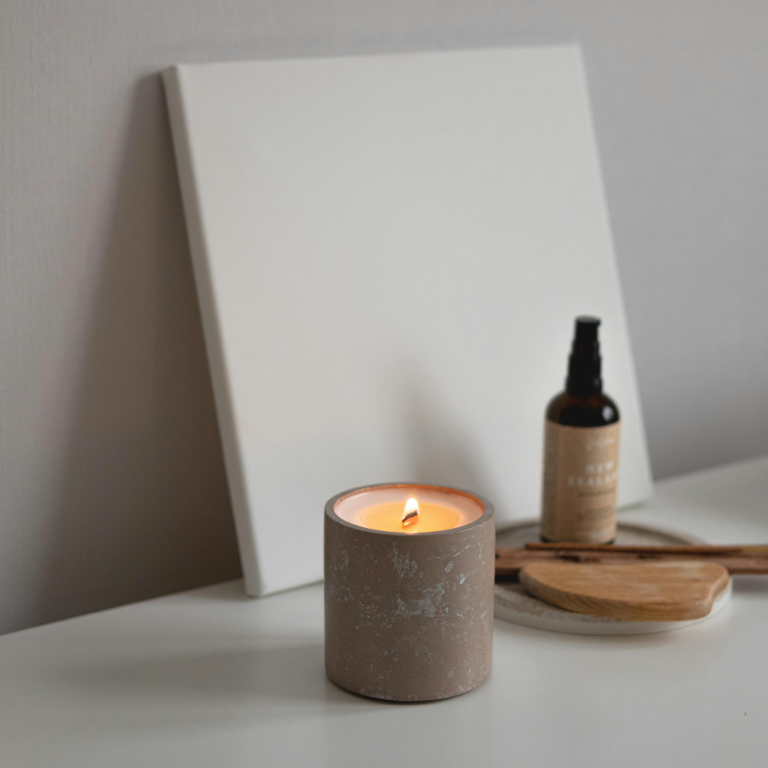 a candle and a bottle of oil on a table, une bougie et une bouteille d'huile sur une table